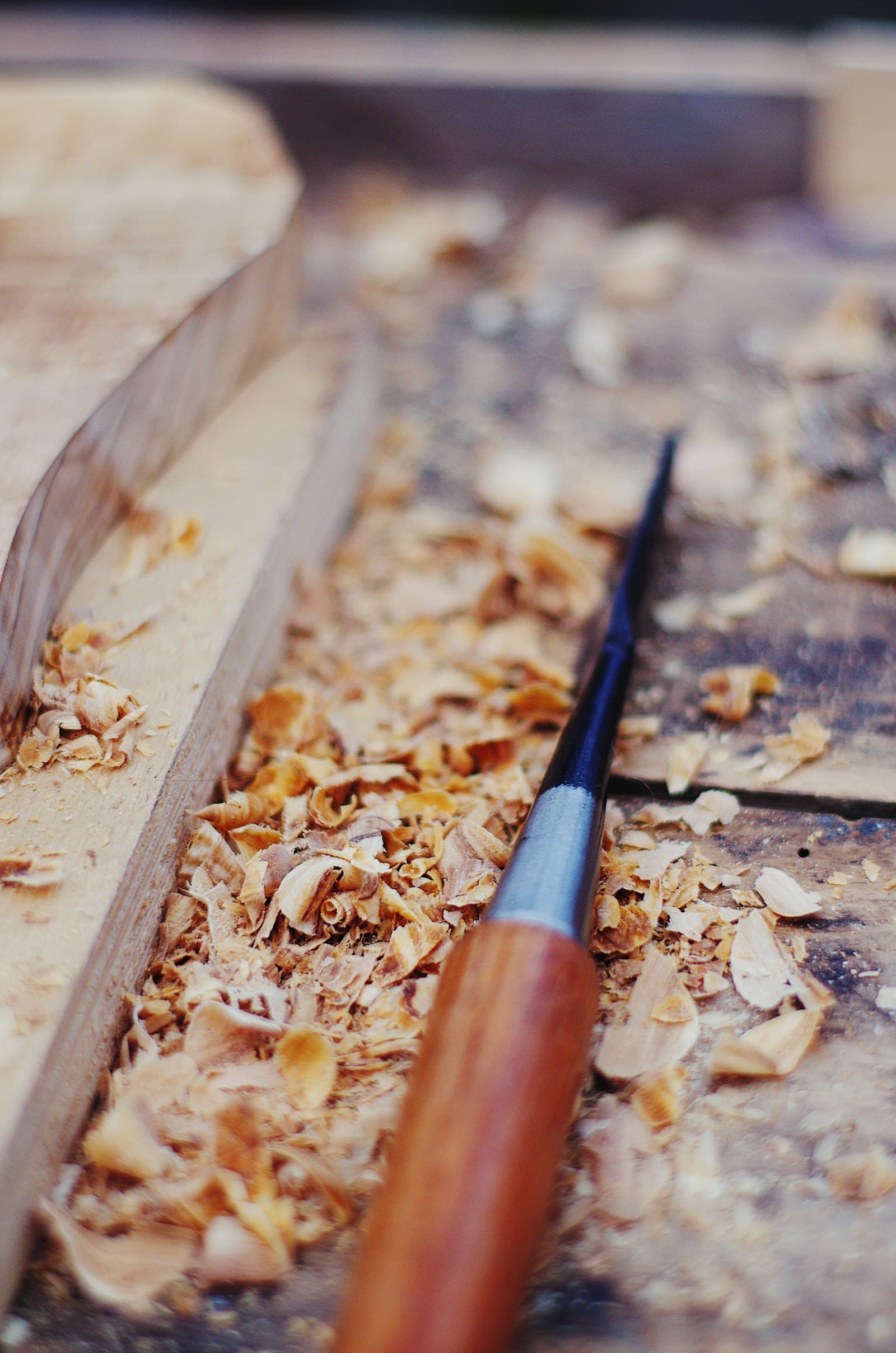 Chisel resting in fresh wood shavings